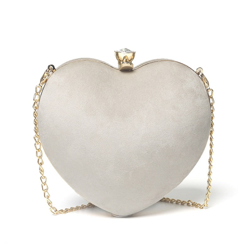 Heart-shaped hand holding chain bag